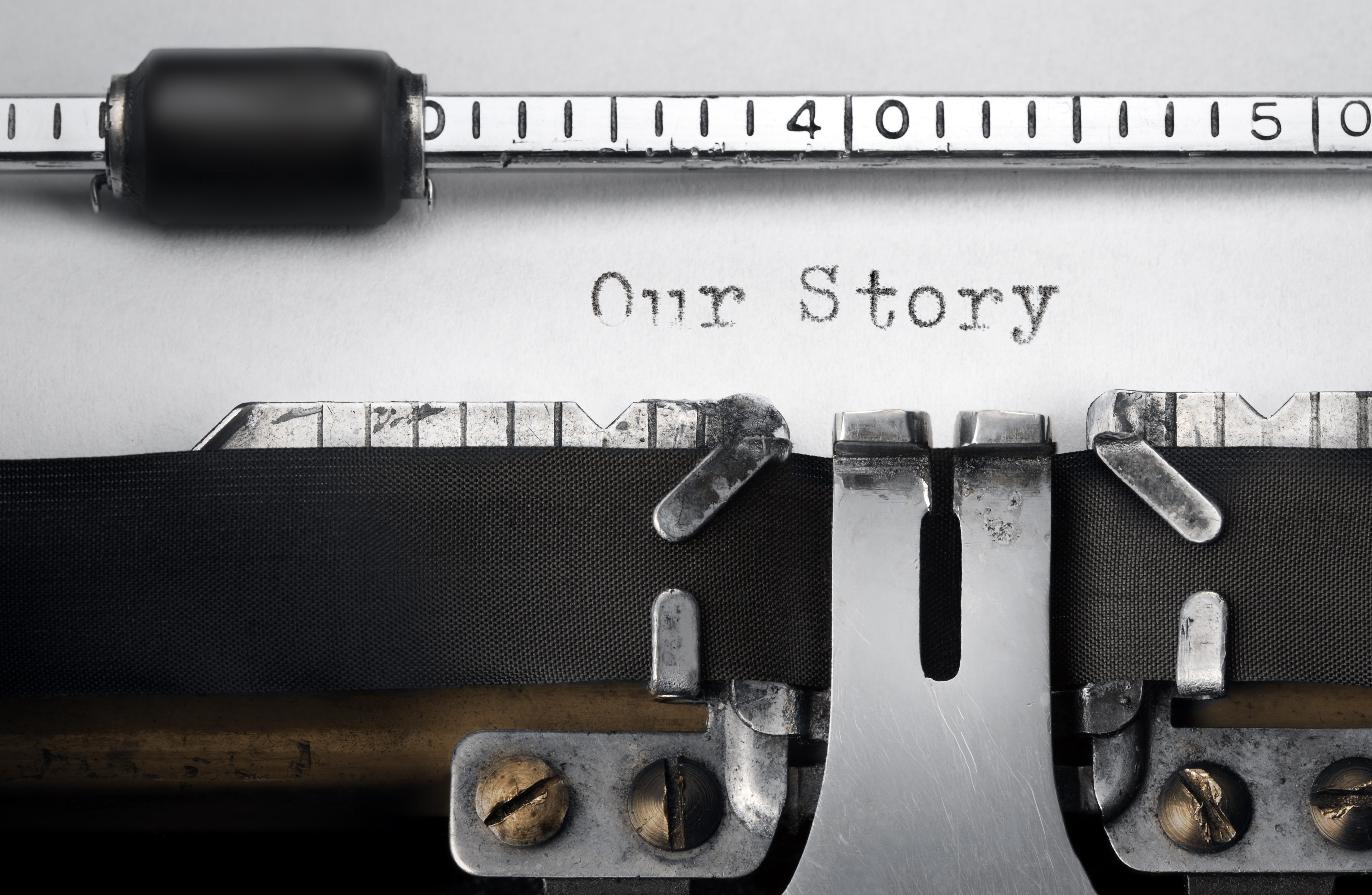 „Our Story“ written on an old typewriter